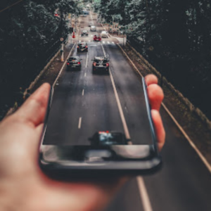 Photo of a smartphone screen merging into a road